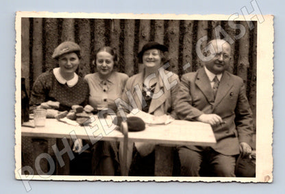 Postcard group at a table early 20th century (M9493)